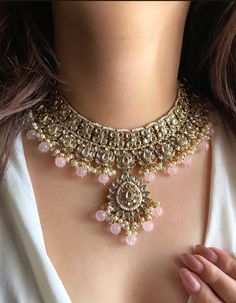 Adorn yourself in timeless elegance with this exquisite Light pink Kundan necklace set, perfect for weddings and special occasions. Crafted with meticulous attention to detail, the set features delicate pink and green hues reminiscent of Pakistani and Punjabi traditions, with a touch of Bollywood glamour. Complete with matching earrings and a stunning maangtika, this Indian Kundan ensemble effortlessly captures the essence of sophistication and grace. Measurements:   Necklace Length-15" Adjustable length with a golden zari dori at the back Width-9"   Earring Length- 2.5" Earring Width-1" Each earring weighs-15 gms  Maangtika Length- 6" Maangtika Width-1.2" Bridal Jewellery Pakistani, Light Pink Necklace, Bollywood Glamour, Kundan Necklace Set, Indian Jewelry Sets, Kundan Necklace, Bollywood Jewelry, Green Hues, Wedding Bridal Jewellery