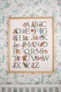 a cross - stitch pattern with letters and animals on it in the corner of a crib