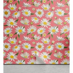 a pink wall with white daisies on it