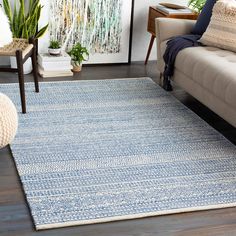 a living room with a couch, chair and rug