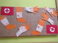 an art project made out of paper and cutouts of hands, socks, and bandages