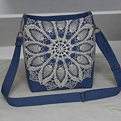 a white and blue purse sitting on top of a table