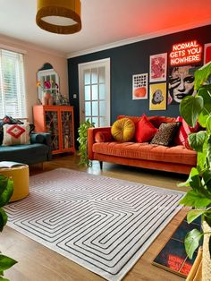 a living room filled with furniture and plants