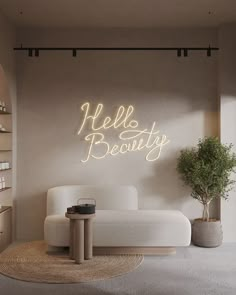 a white couch sitting next to a table on top of a rug in a living room