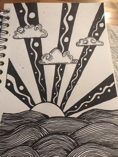 a drawing of the sun and clouds in black and white on a piece of paper