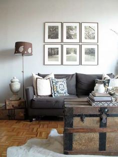 a living room filled with furniture and pictures on the wall above it's coffee table