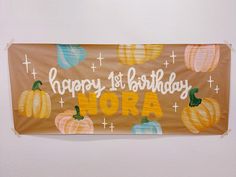 a happy 1st birthday banner with pumpkins on it and the words hora written in white