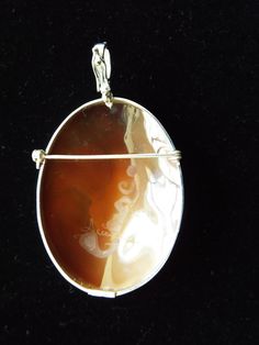 "This is an amazing cameo bezel set in Italian silver with an enhancer (5mm) and a pin attachment. It is museum quality hand carved sardonyx cameo and one of kind. It is 50 mm (1.97\") by 37 mm (1.46\"). This a museum quality carved cameo signed by the famous, Accanito. It is amazing like the paintings you have seen it in Italy. You can have a hand carved one of kind cameo around your neck! This pendant comes with a black velvet box and certificate of authenticity. Item Number 551 992018 Welcome Bezel Setting, Black Velvet, Brooches, Hand Carved, Carving, Drop Earrings, Pendant, Silver