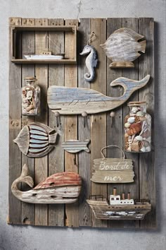 a wooden wall with various sea animals and other items on the wood paneled wall