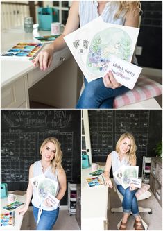 a woman sitting at a desk holding up some cards