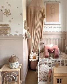 a small child's room with pink and white decor on the walls, bed in the corner