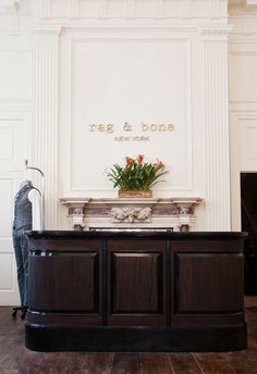 a large wooden desk sitting in front of a white wall