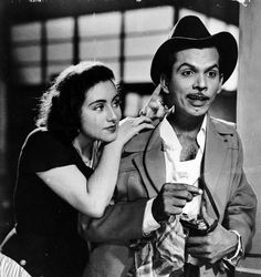 an old black and white photo of a man brushing his teeth next to a woman