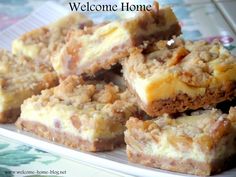 several pieces of dessert on a plate with the words welcome home written in white letters