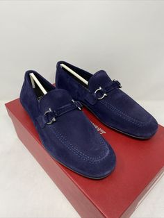 Salvatore Ferragamo Sander Horsebit Navy Logo Suede Loafers Size: 6.5 E Color: Navy Suede  Brand New In Box 100% Authentic Guaranteed Iconic horsebit hardware takes on the form of Salvatore Ferragamo's hardware on these loafers. -Suede upper -Almond toe -Slip-on style -Leather lining -Leather sole -Made in Italy All our items are 100% Authentic Guaranteed  Item pictured is item being sold. Please review all pictures carefully before purchasing. Please feel free to message me with any questions! Designer Loafers With Buckle Closure, Navy Logo, Ferragamo Shoes, Suede Loafers, Salvatore Ferragamo, Boat Shoes, Dress Shoes Men, Men's Shoes, Dress Shoes