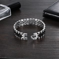 Perfect for the modern man, this wristband combines classic sophistication with contemporary vibes for timeless appeal. DESIGN – Durable bracelet with a bold chain design. FEATURES – Easy hook clasp. Length 200mm. Width 15 mm. MATERIAL – Stainless Steel. Elegant Black Link Chain Bracelet, Modern Cuban Link Bracelet, Modern Metal Cuban Link Bracelet, Modern Black Stainless Steel Cuff Bracelet, Modern Black Chain Link Jewelry, Black Jewelry With Rectangular Box Chain Links, Modern Stainless Steel Cuban Link Bracelet With Adjustable Chain, Modern Silver Wristband With Stainless Steel Clasp, Modern Black Link Chain Bracelet