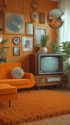 a living room with an orange couch and television