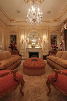 a fancy living room with chandelier and couches