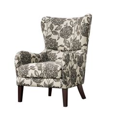 an upholstered chair with floral print on the back and arms, sitting against a white background