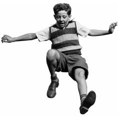 a young boy is jumping in the air