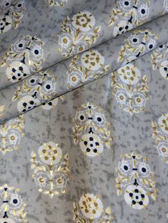 the fabric is very pretty with gold and blue flowers on it's grey background