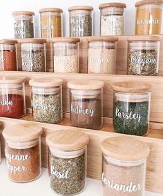 spice jars with labeled labels on them sitting on a shelf