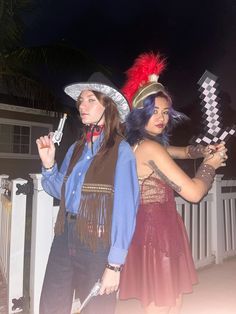 two women dressed in costumes standing next to each other