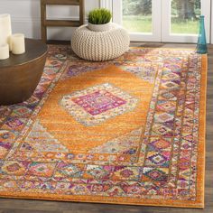 a living room with an orange rug on the floor