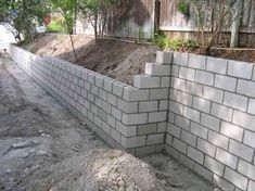 a brick wall is being built into the ground