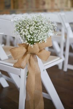 a bouquet of baby's breath tied to a chair