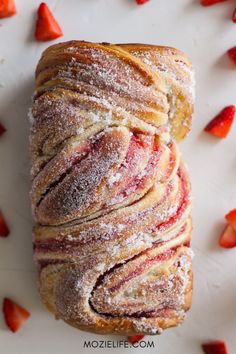 a pastry with powdered sugar and strawberries on it