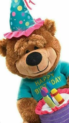 a brown teddy bear wearing a birthday hat and holding a cake with candles in it