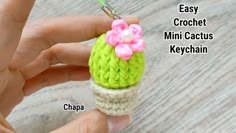 a crochet keychain made to look like a cactus with pink flowers