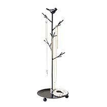 a black and white photo of a coat rack with three birds on it's branches