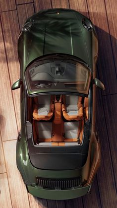 an overhead view of a green sports car with its doors open and seats folded down