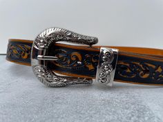 Large engraved chrome buckle W 9cm,  H 6.5 cm Embossed floral pattern. Has a metal belt keeper thats fixed in place and a metal end tip. Leather backing.  Size 79 -94 cm. Width 3 cm Please note this is a vintage item (second hand / not new) , so may have signs of wear. However, anything major will be listed and photographed. Formal Adjustable Concho Belt, Western Engraved Belt For Formal Occasions, Western Style Engraved Belt For Formal Occasions, Silver Belt With Buckle Closure For Formal Occasions, Formal Adjustable Engraved Belt, Silver Western Belt For Formal Occasion, Western Style Silver Belt For Formal Occasions, Western Silver Belt With Buckle, Western Silver Belt With Buckle Closure