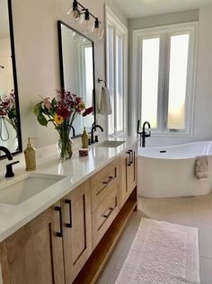 a large bathroom with two sinks and a bathtub