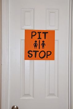 a white door with an orange sign that says pit stop on the front and side