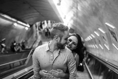 a man and woman standing next to each other on an escalator