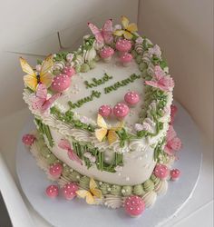 a birthday cake decorated with flowers and butterflies