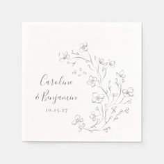 a white wedding napkin with flowers and leaves on the front, printed in black ink