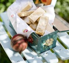 some food that is sitting on a table next to a ball and bag with something in it