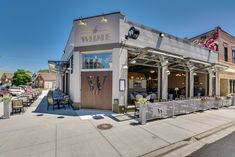 the outside of a restaurant with tables and chairs