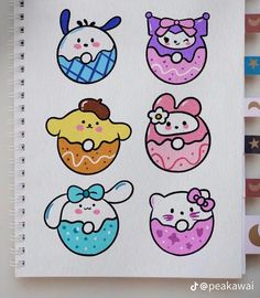 an open notebook with drawings of donuts and cartoon characters on the pages, including hello kitty