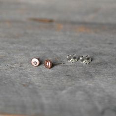 "14k rose gold, sterling silver and natural brown diamond post earrings. I melted the little pebbles from a pieces of rich 14k recycled rose gold and hammered them into sweet little pebble shapes. I then set each pebble with a sparkly 2mm champagne colored diamond. Because of the handmade process by which these earrings are made, the organically shaped \"pebbles\" are not perfectly matched, yet they go perfectly together like two pebbles collected along the same shore. These minimalist earrings, Hand Forged Rose Gold Sterling Silver Earrings, Tiny Diamond Earrings, Earrings Bride, Earrings Rose Gold, Bride Jewelry, Gold Disc, Tiny Diamond, Brown Diamond, Diamond Gold