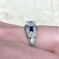 A stunning Art Deco style engagement ring that centers a GIA-certified 0.89 carat old European cut diamond, H color and VS1 clarity. The shoulders feature baguette sapphires, old cut diamonds, and fine filigree. This ring is entirely platinum, handcrafted in the style of the Art Deco era.
The center stone features stunning antique characteristics such as a small table and open culet.
A copy of the GIA certificate is available upon request.
This ring is currently size 6 and can be resized to any Timeless Sapphire Baguette Cut Ring, Timeless Sapphire Ring With Diamond Baguette Cut, Timeless Sapphire Baguette Cut Ring With Diamond Details, Classic Formal Diamond Ring With Lab-created Sapphire, Classic Gia Certified Emerald Cut Sapphire Ring, Art Deco Gia Certified Sapphire And Diamond Ring, Art Deco Gia Certified Sapphire Ring With Diamond, Art Deco Sapphire Ring With Gia Certified Diamond, Classic Emerald-cut Sapphire Diamond Ring