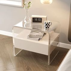 a glass table with books and a clock on it