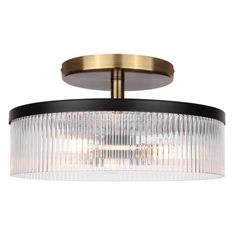 a semi flush ceiling light fixture with clear glass and gold trimmings on the rim