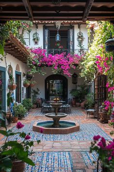 an outdoor courtyard with flowers and potted plants