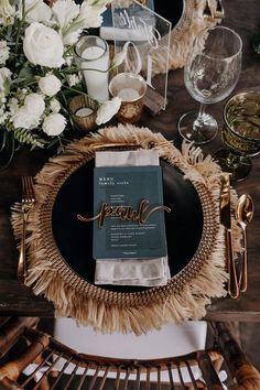 a table setting with place settings, napkins and flowers